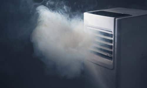Impianto di aspirazione del fumo localizzato. Sfondo nero con del fumo grigio che viene aspirato dalle ventole dell'impianto